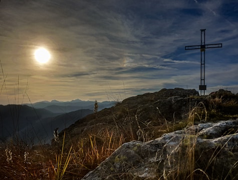 A film crew filming a heartfelt biblical scene outdoors at sunset.