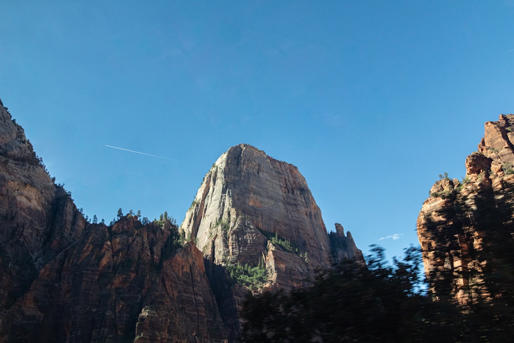 a rocky mountain with trees