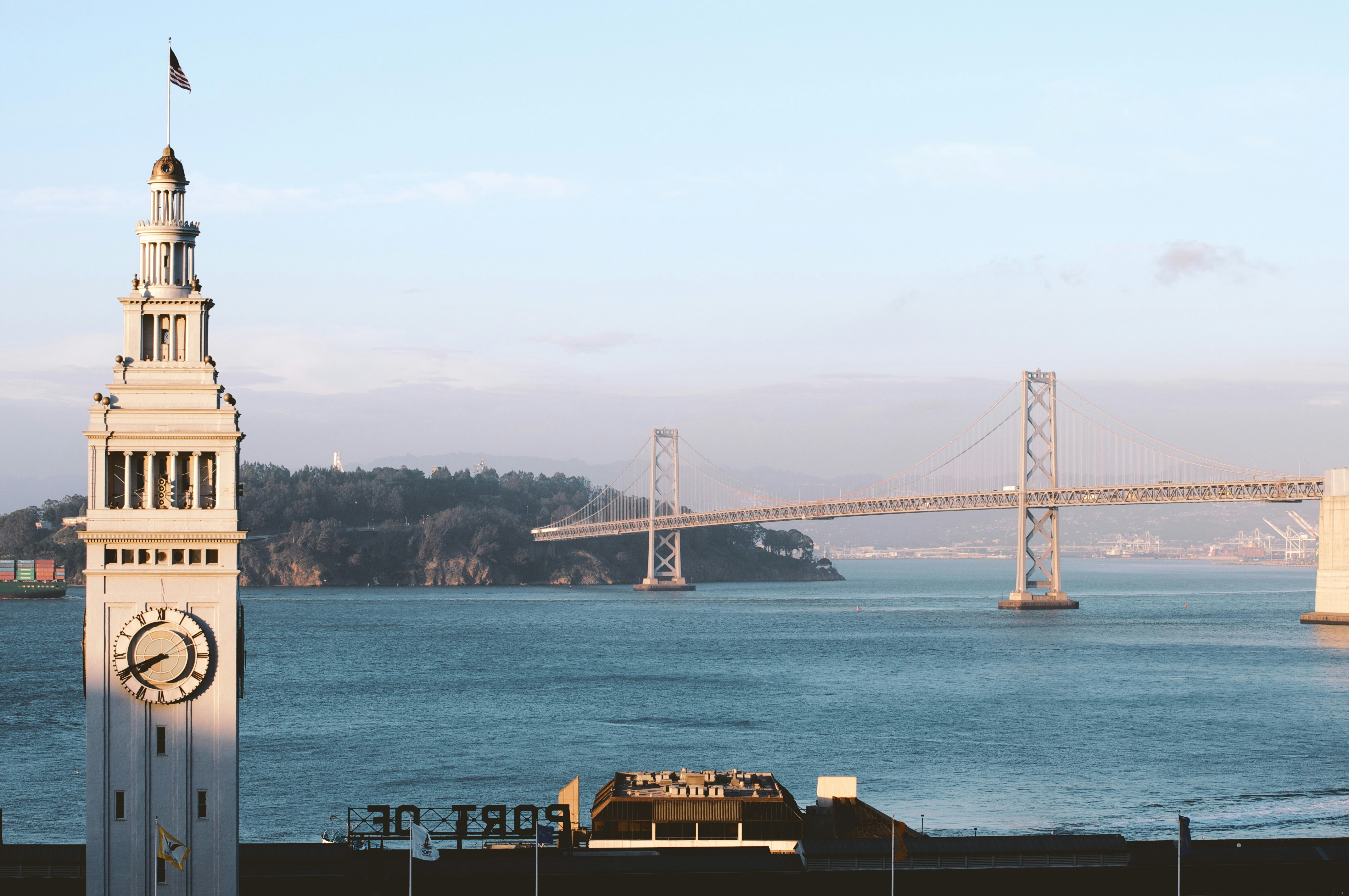 a clock tower next to a body of water
