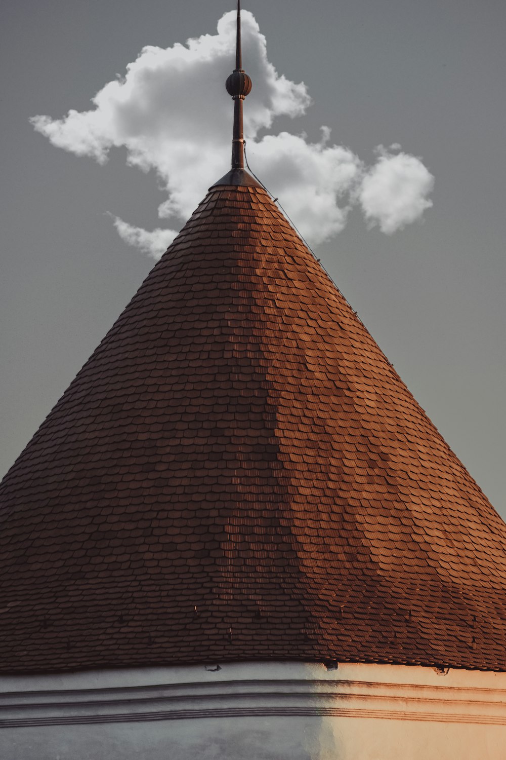 a tall brick building with a cloud of smoke