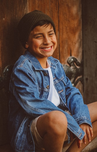 a person smiling and wearing a hat