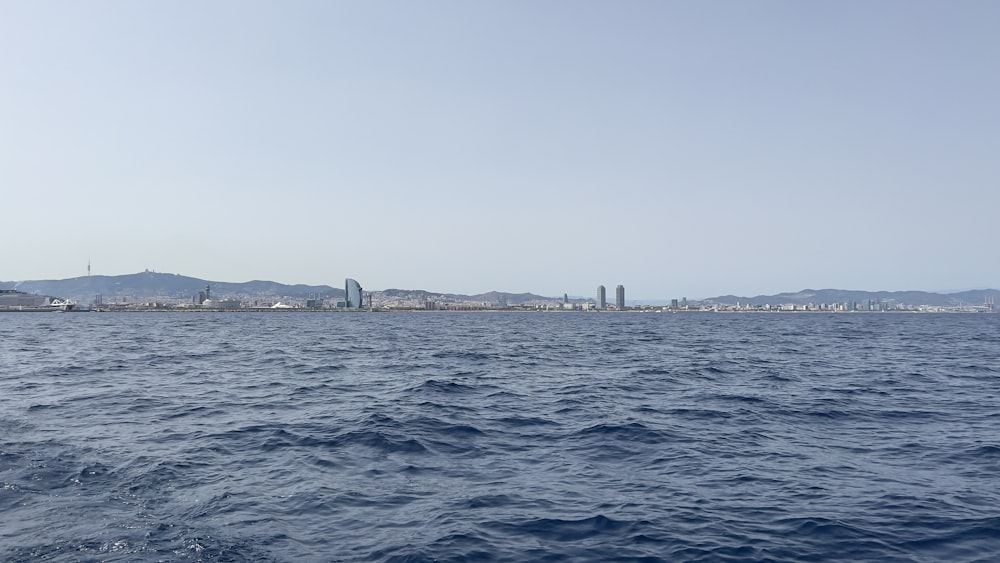 a body of water with a city in the distance