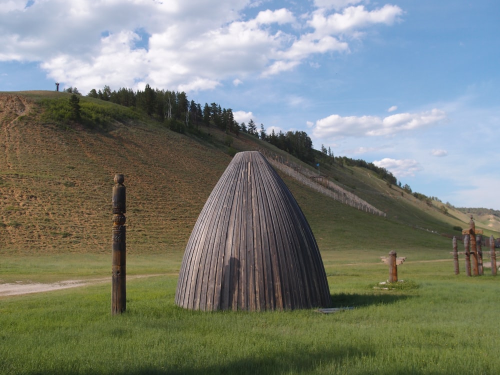 a grass hill with a building on it