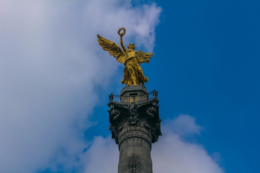 a golden statue on a pillar