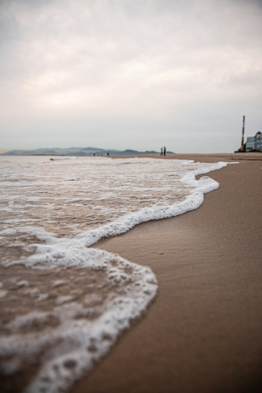 a beach with waves crashing on it