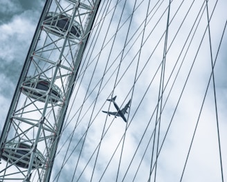 a plane flying over a ferris wheel