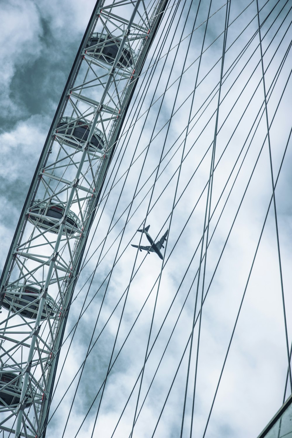 a plane flying over a ferris wheel