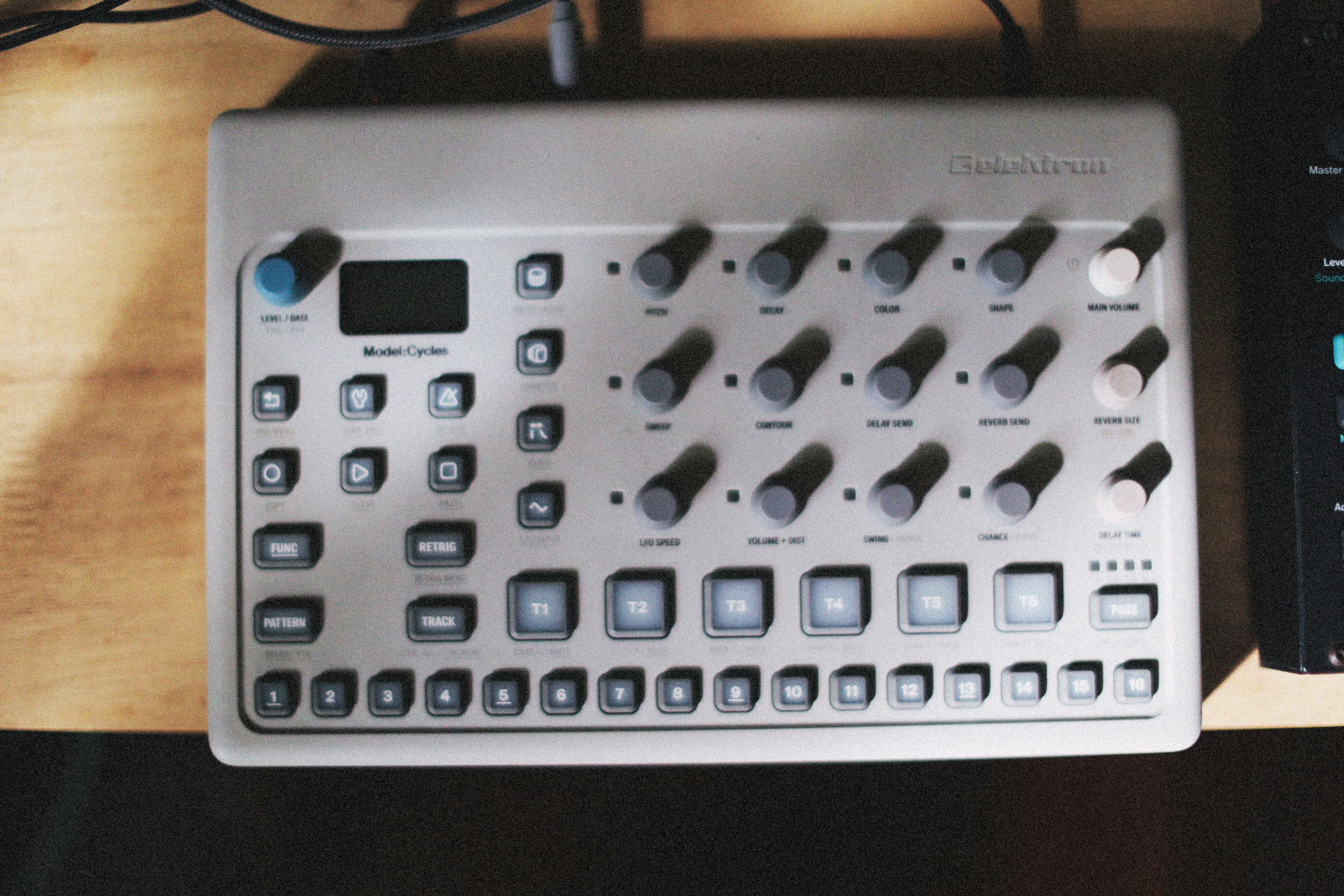 a white calculator on a wooden surface