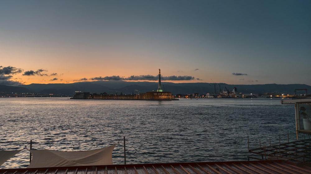 a body of water with a tower in the distance