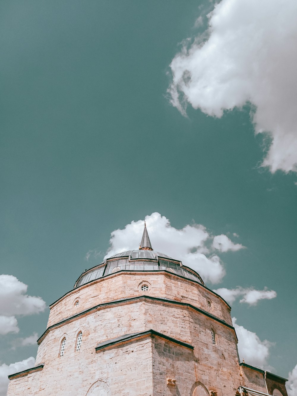 a tall building with a cloudy sky