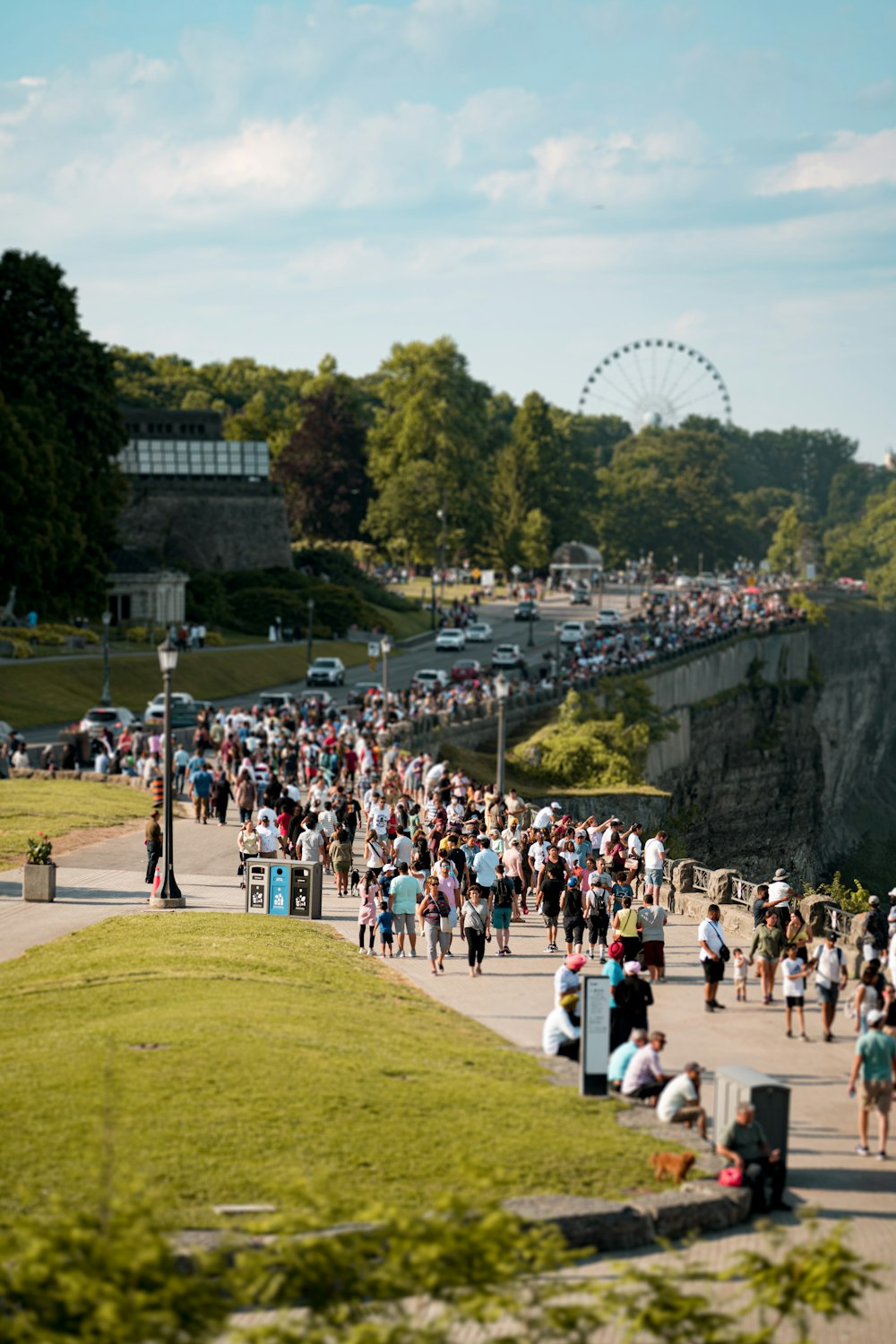 a crowd of people walking on a sidewalk