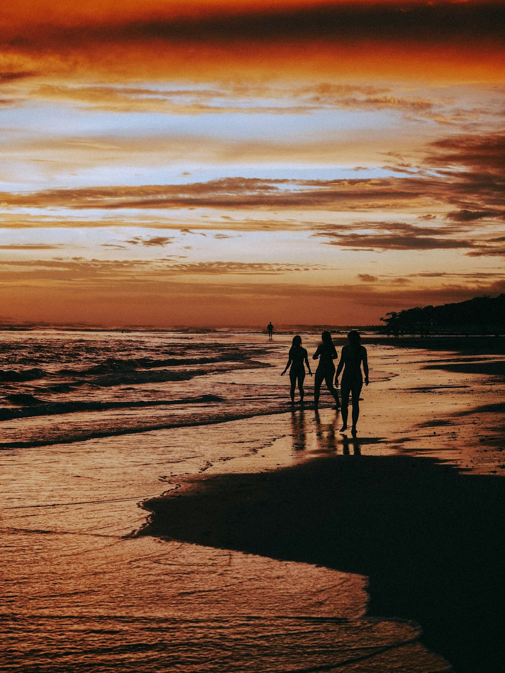 a group of people walking on a beach