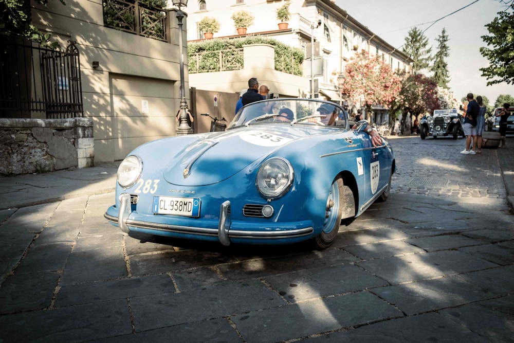 a blue car parked on a street