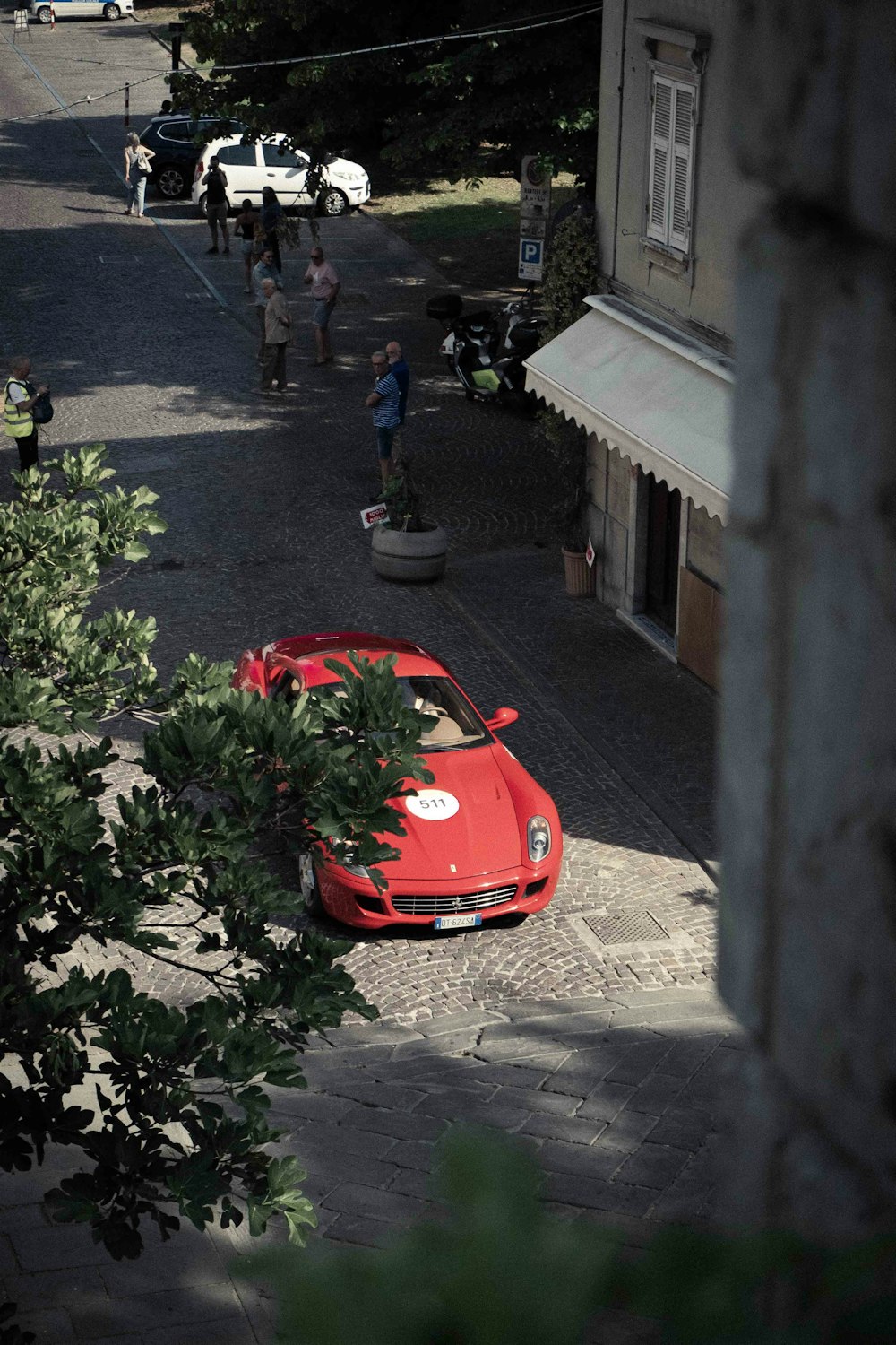 a red car parked on the side of a road