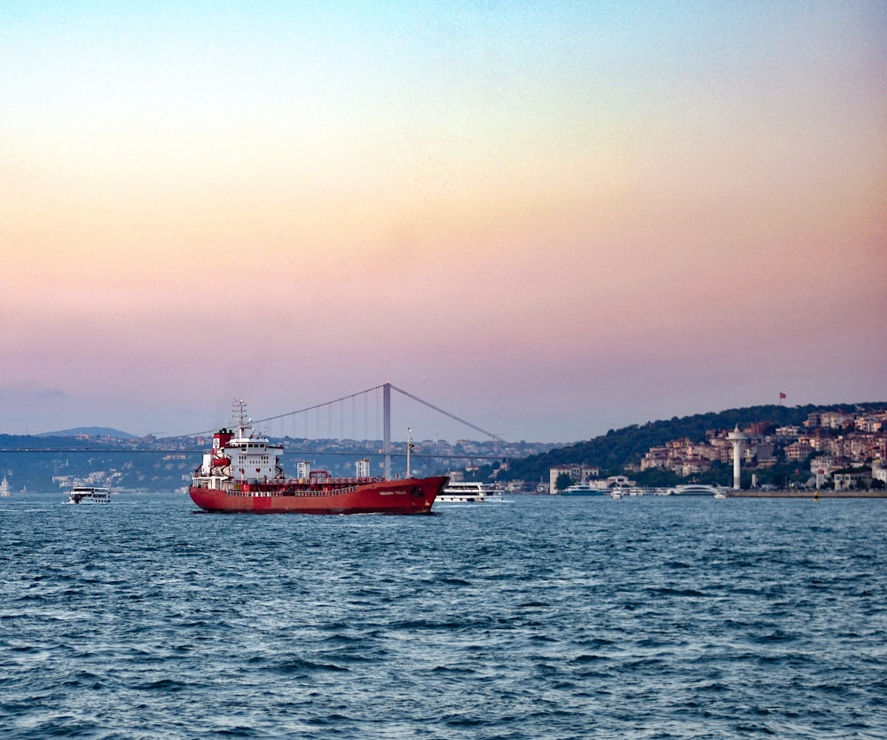 a large red ship in the water