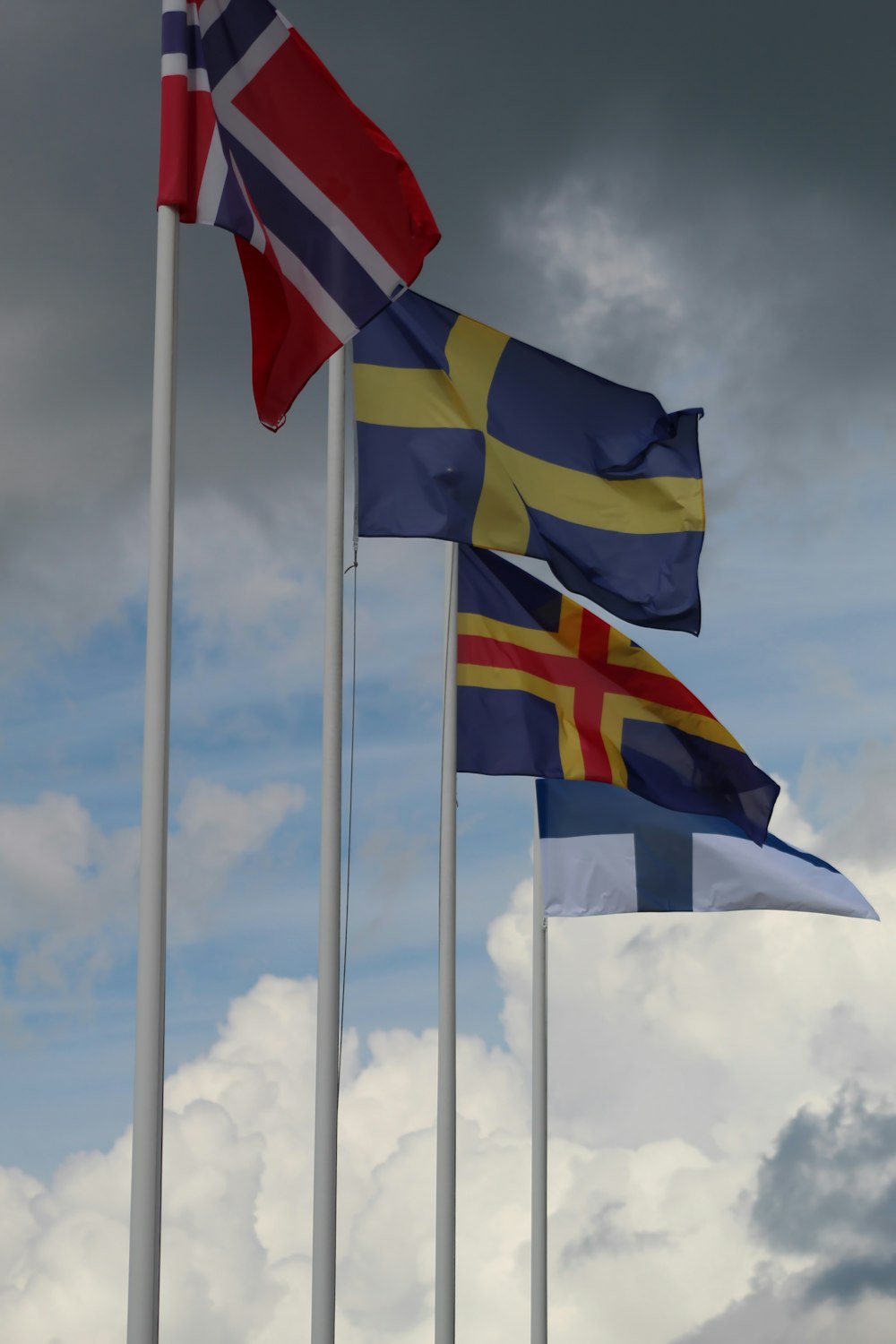 a group of flags on poles