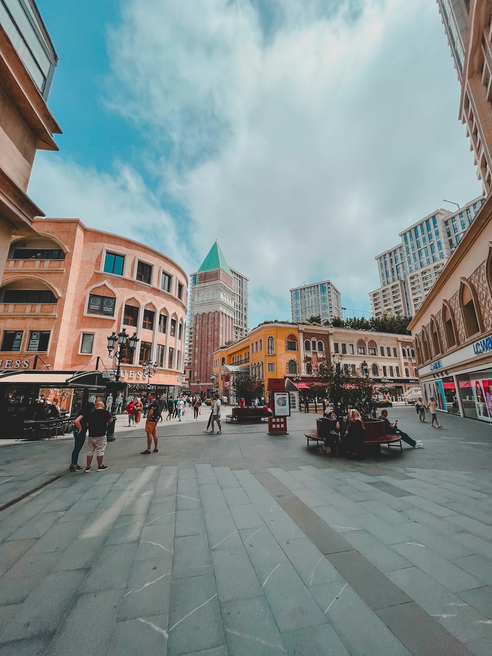 a city square with people walking around