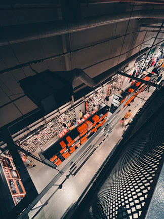 Busy retail store with colorful products and customers browsing shelves.
