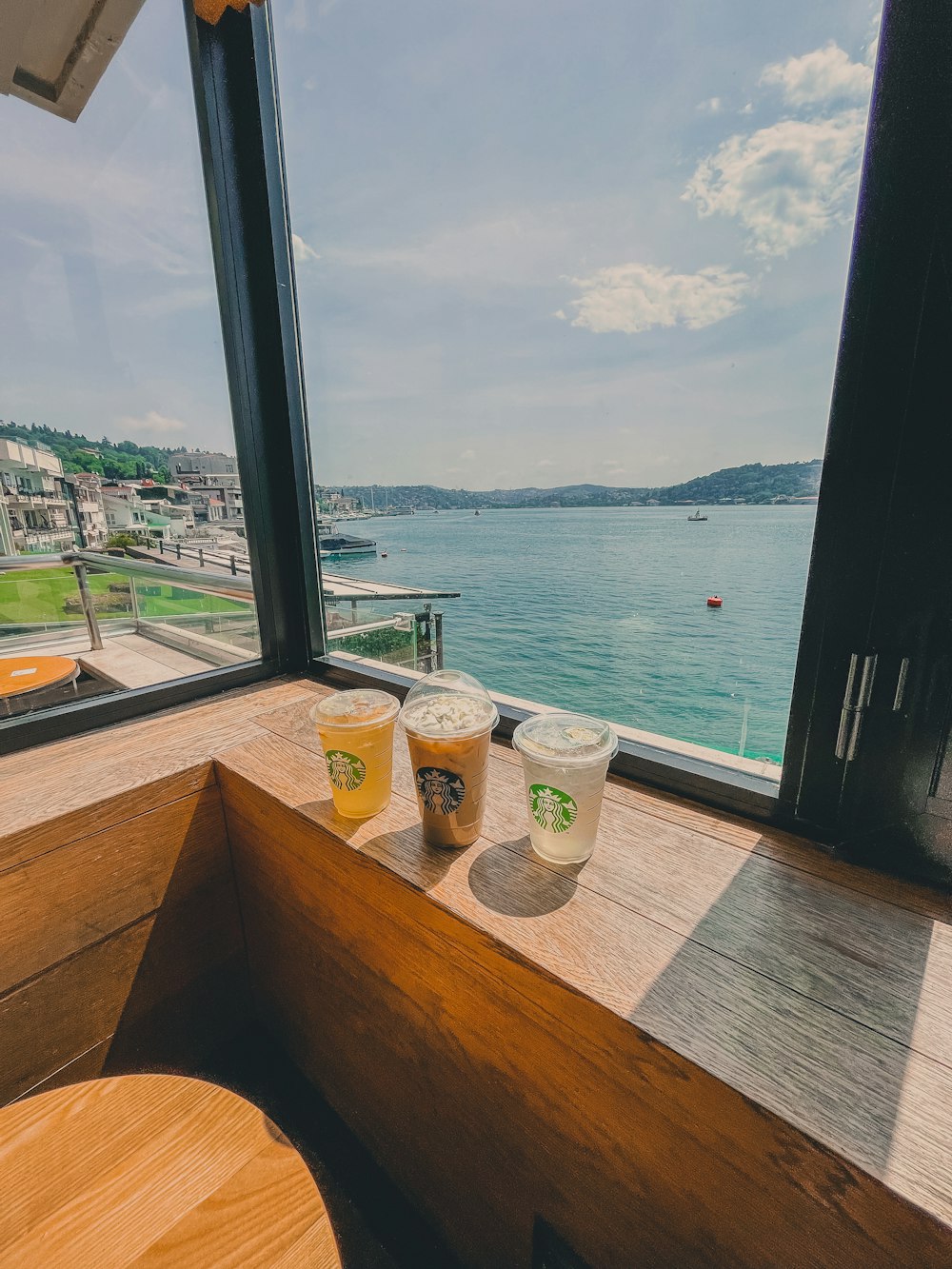 a table with cups on it by a body of water