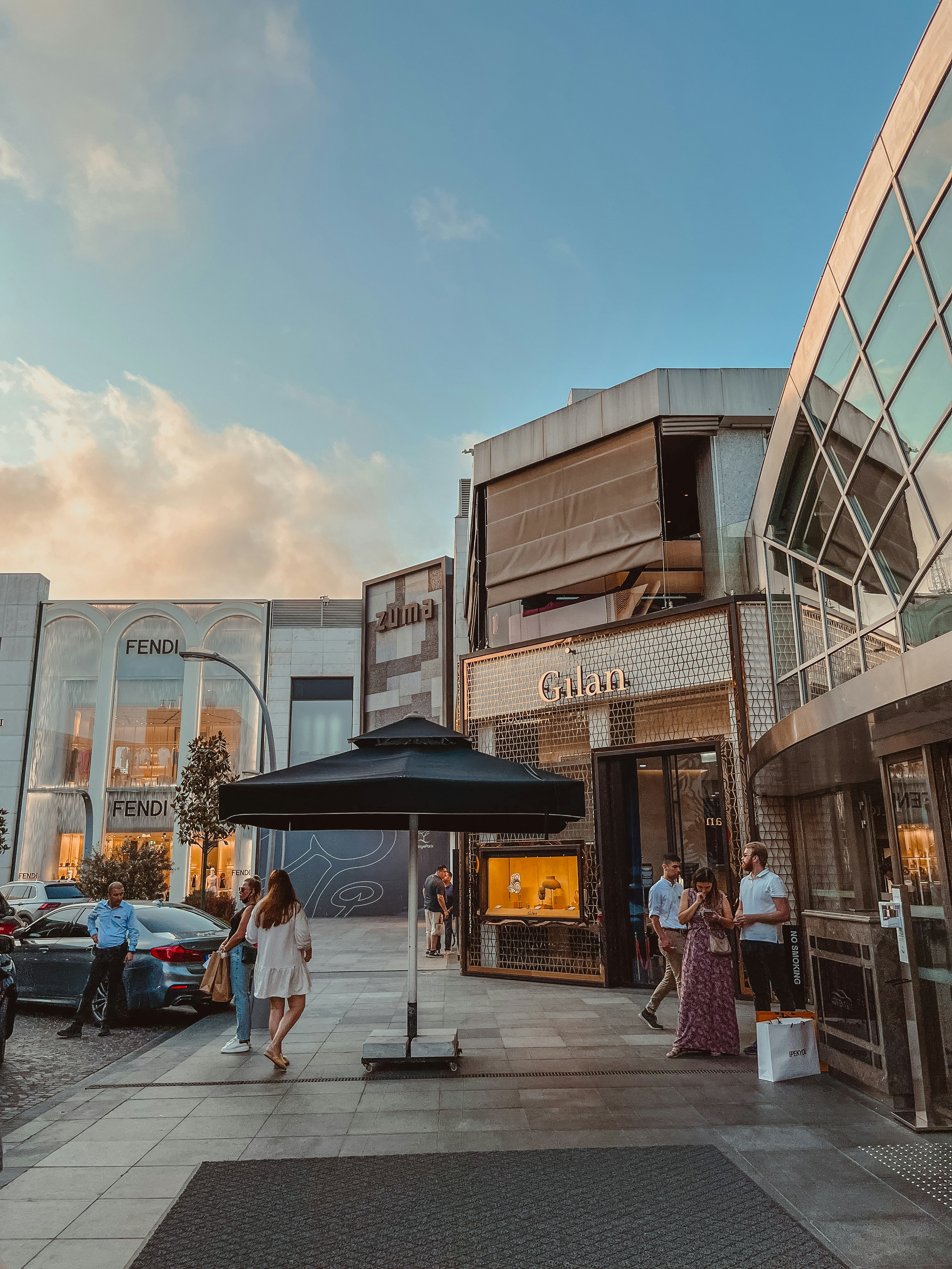 people walking on a sidewalk