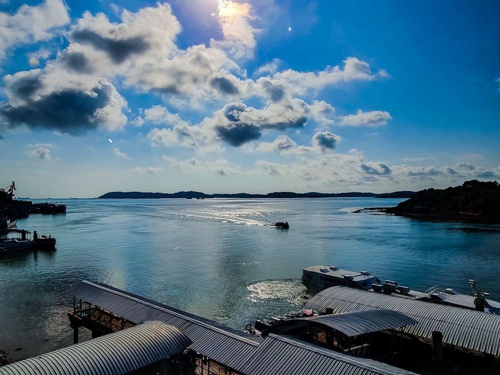 a body of water with boats and a cloudy sky