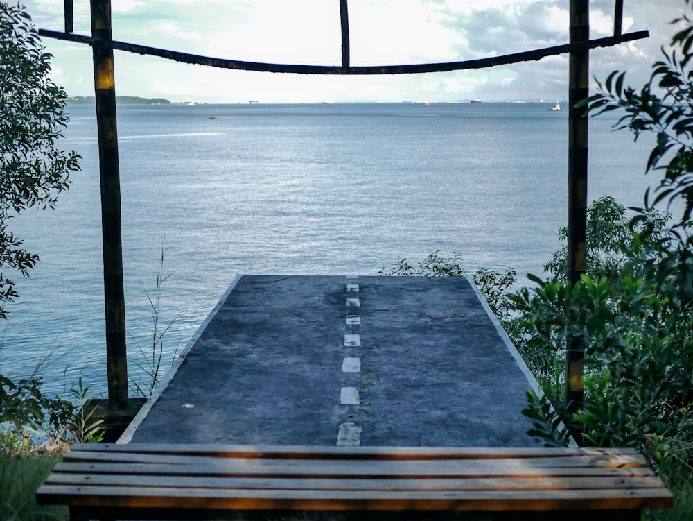 a wooden bench overlooking a body of water