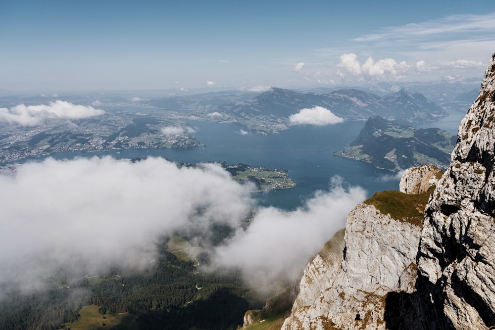 a view of a valley with clouds and mountains in the background