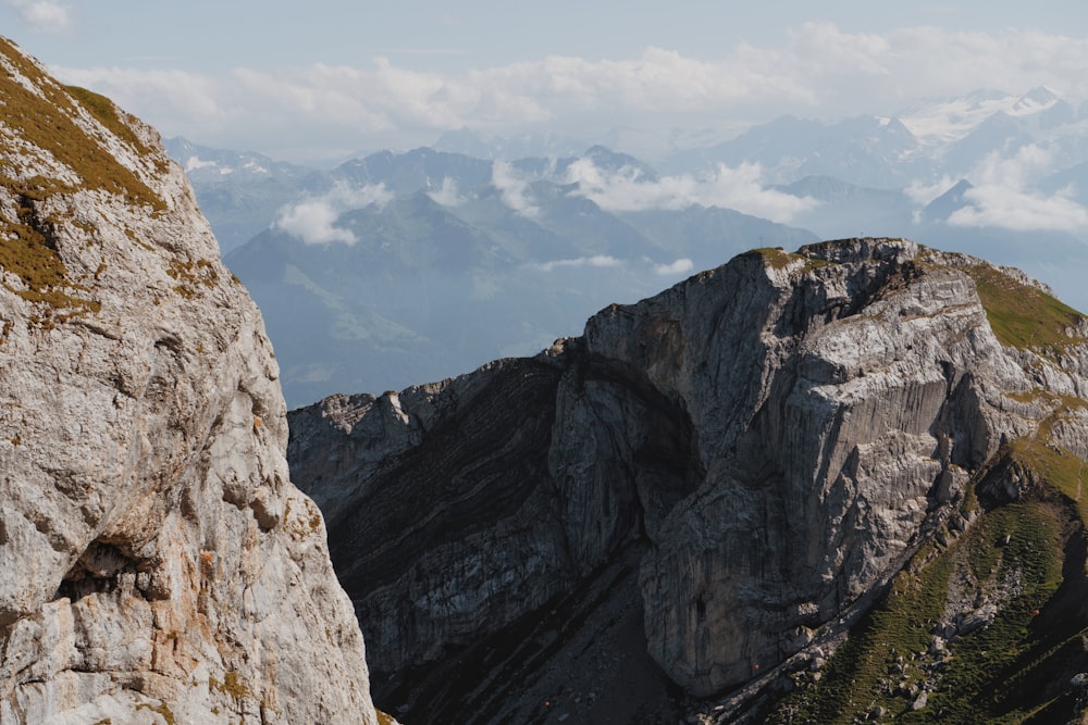 a rocky mountain with clouds in the background