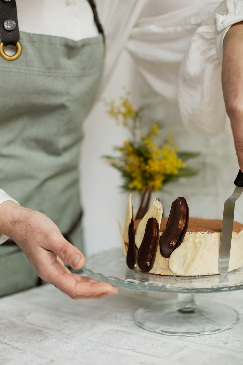 a person cutting a cake