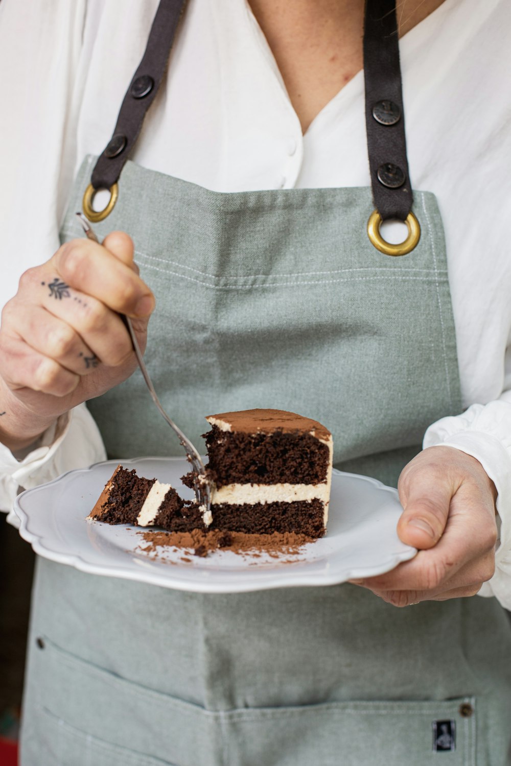 a person cutting a cake