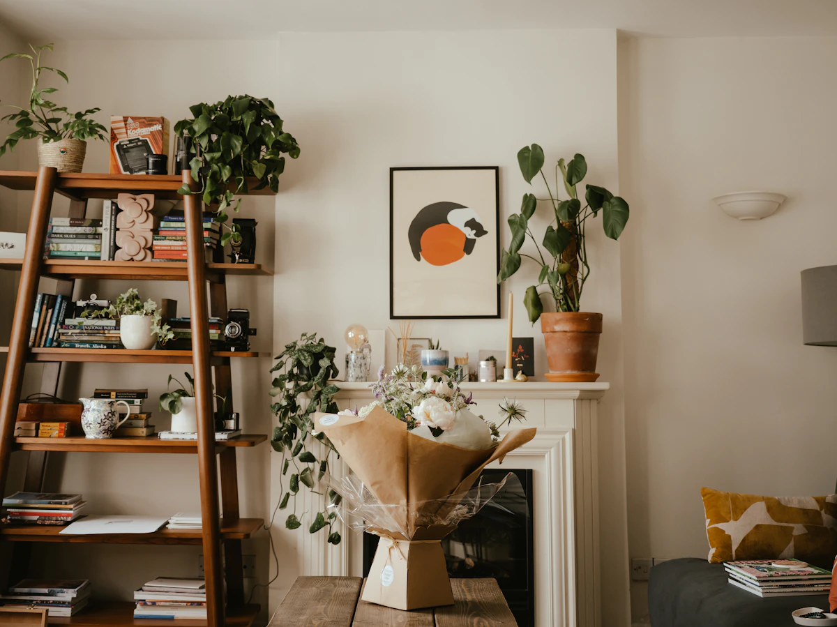 Living room with wood flooring, fireplace and potted plants