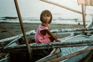 a girl in a boat on the beach