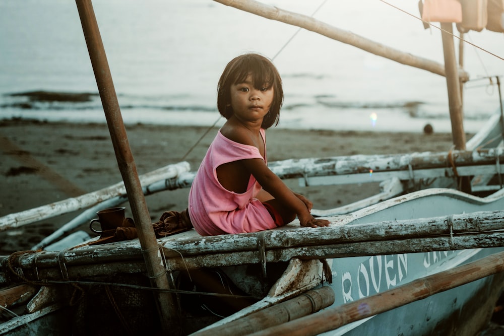 a girl in a boat on the beach