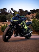 A stylish electric motorcycle displayed on a scenic road.