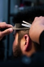 a man with a beard and a hair clipper on his head