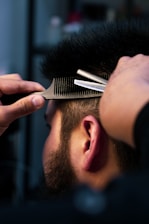 a man with a beard and a hair clipper on his head