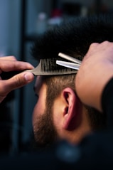 A close-up of a well-groomed beard being trimmed.