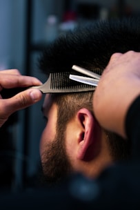 A close-up of a well-groomed beard being trimmed.