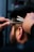 A close-up of a well-groomed beard being trimmed by a barber.