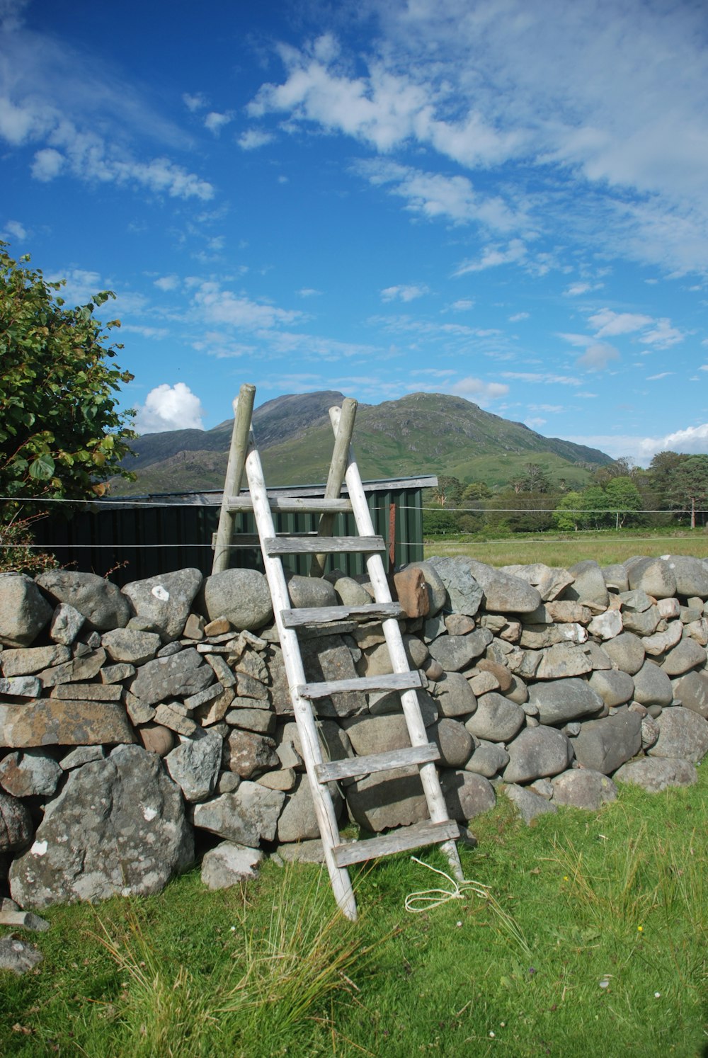 a ladder leaning against a stone wall