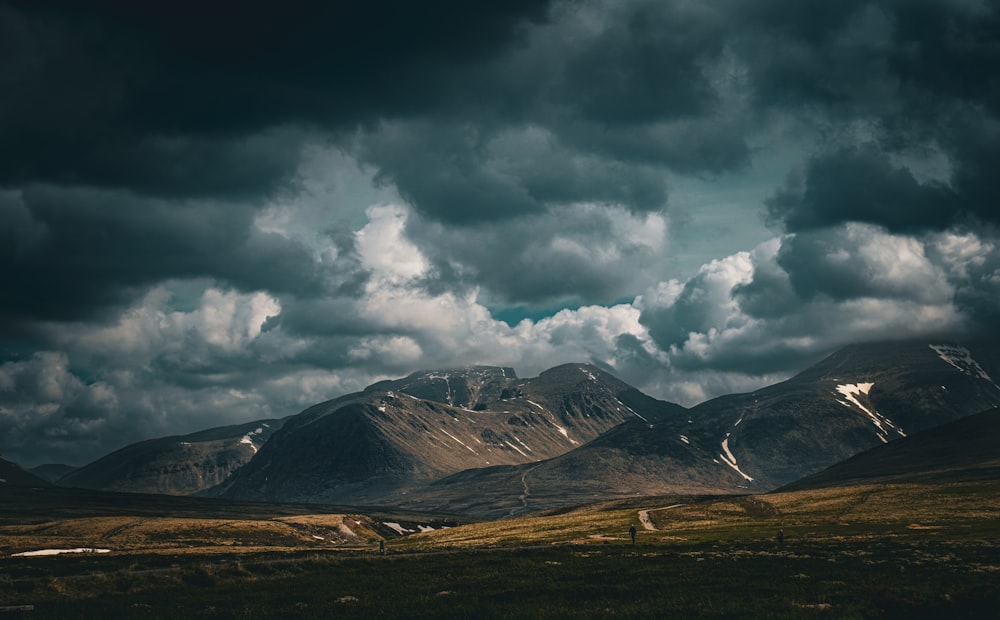 a landscape with mountains and clouds