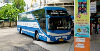 a blue bus parked on the side of a street