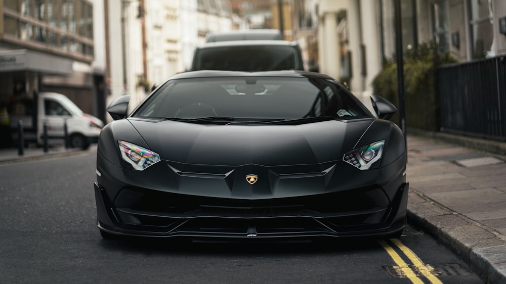 a black car parked on the side of a street