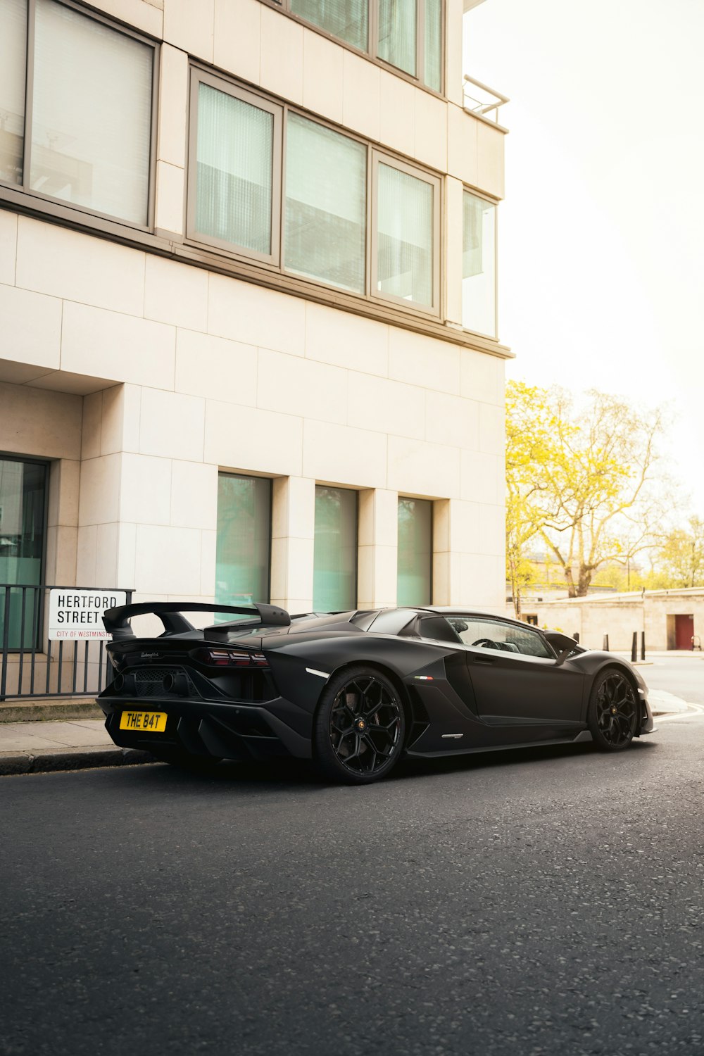 a black sports car parked in front of a building