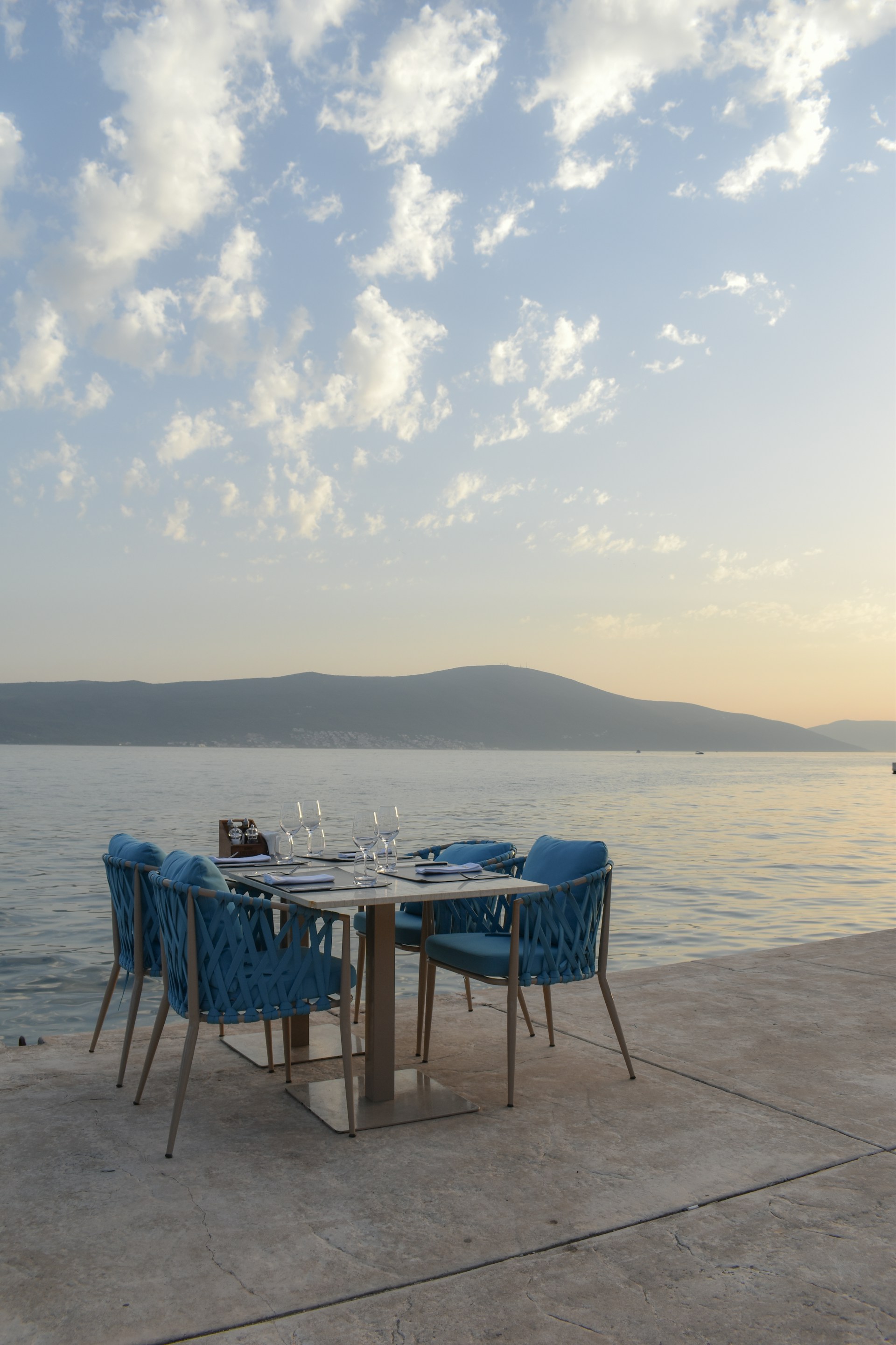 a table and chairs on a dock