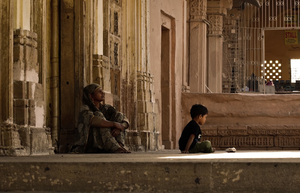 a man and a child sitting on a ledge