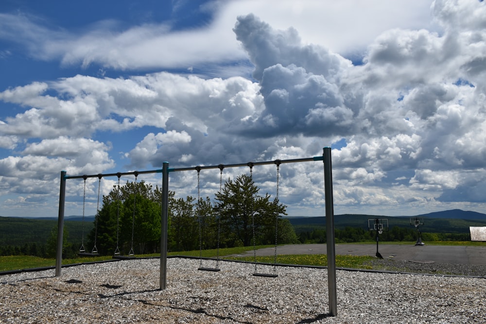 a fenced off area with a road and trees in the background