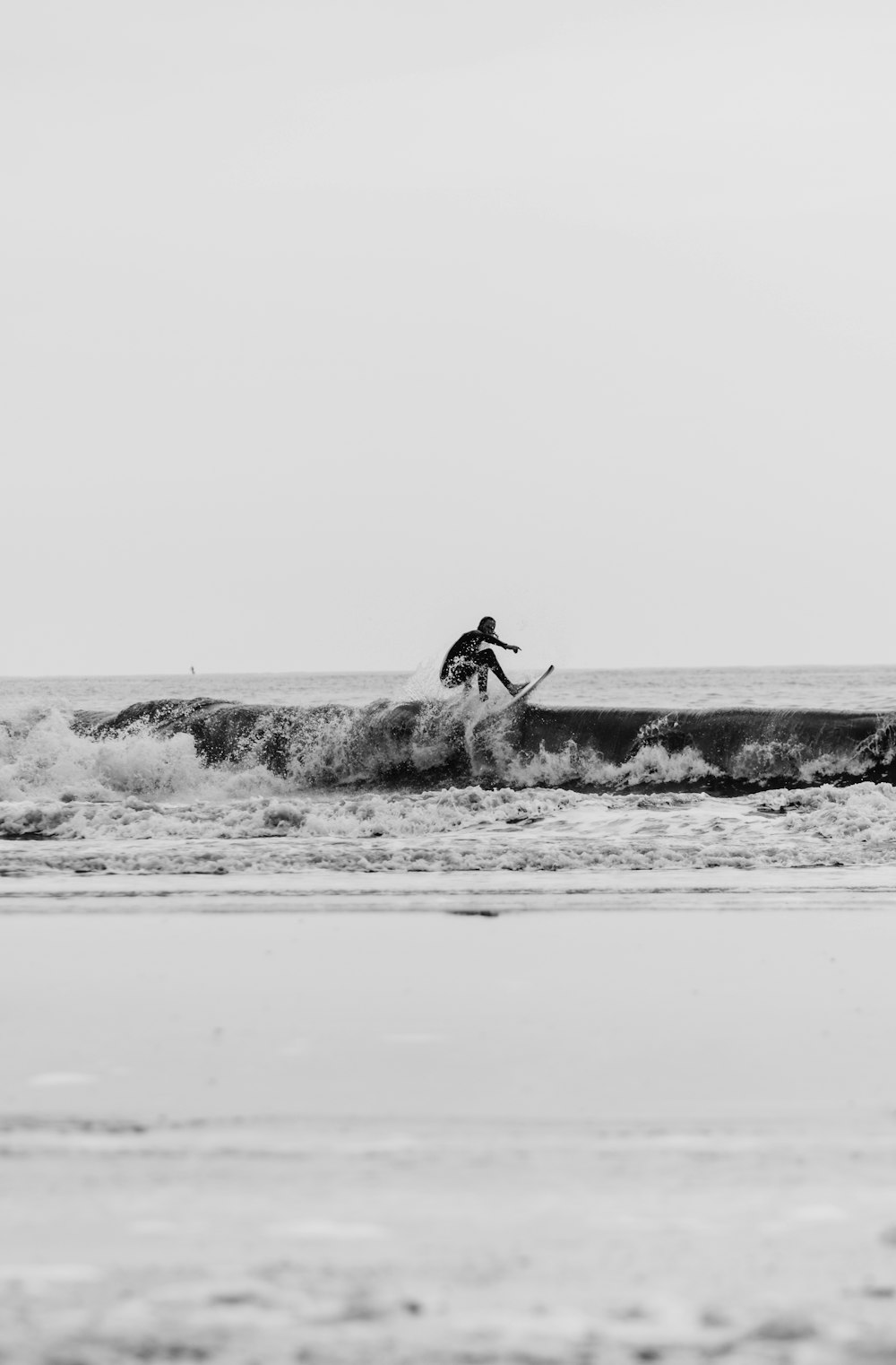 a sandy beach next to a body of water