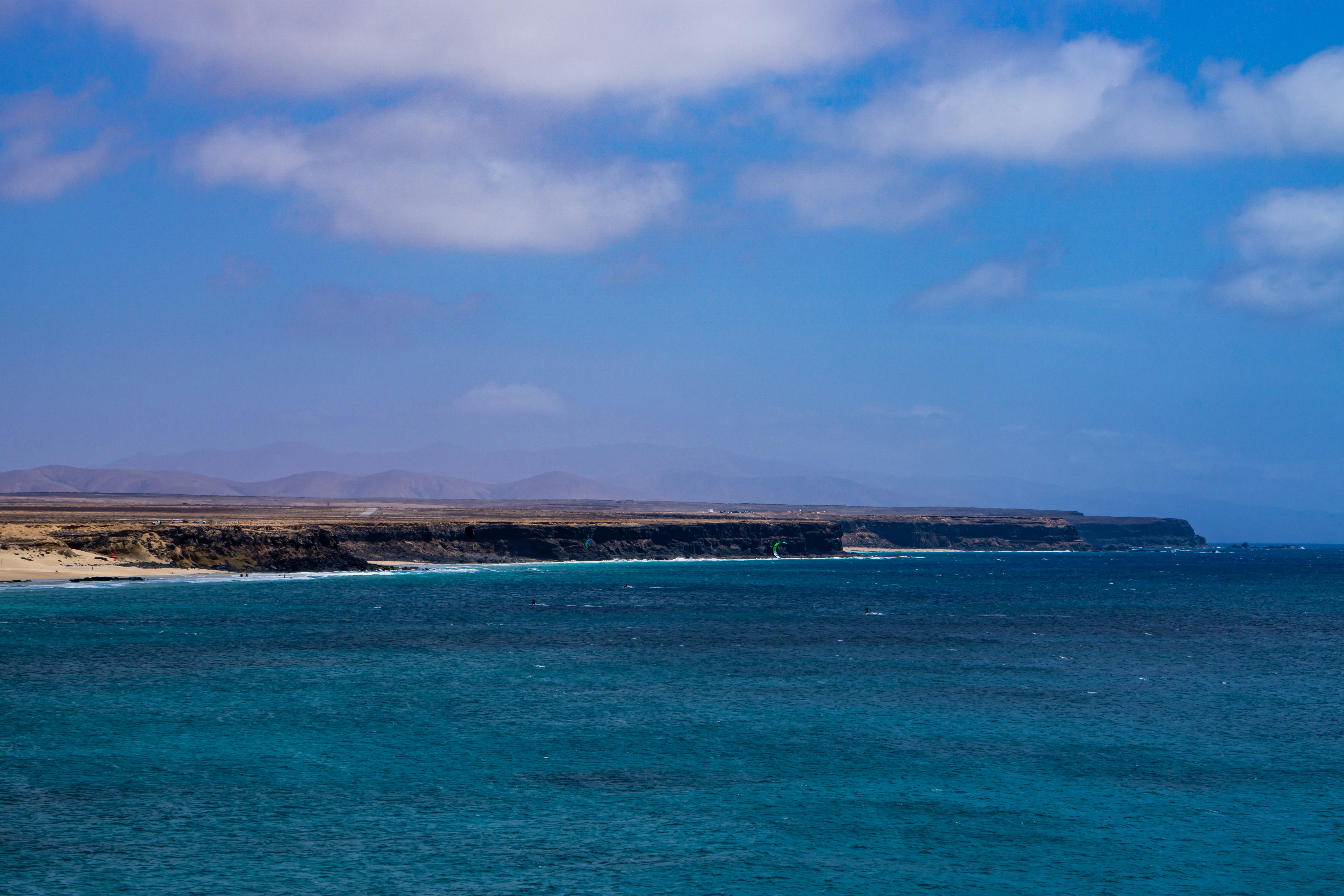 a body of water with land in the distance, 