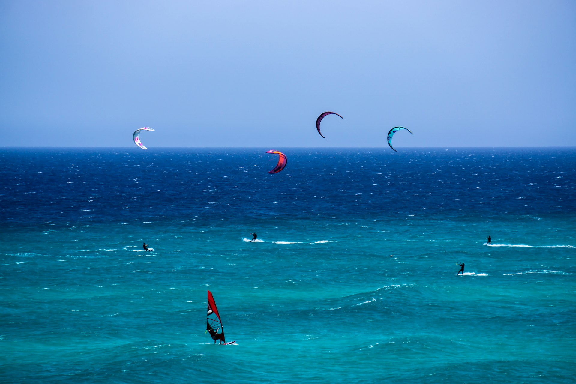people are kite surfing in the sea